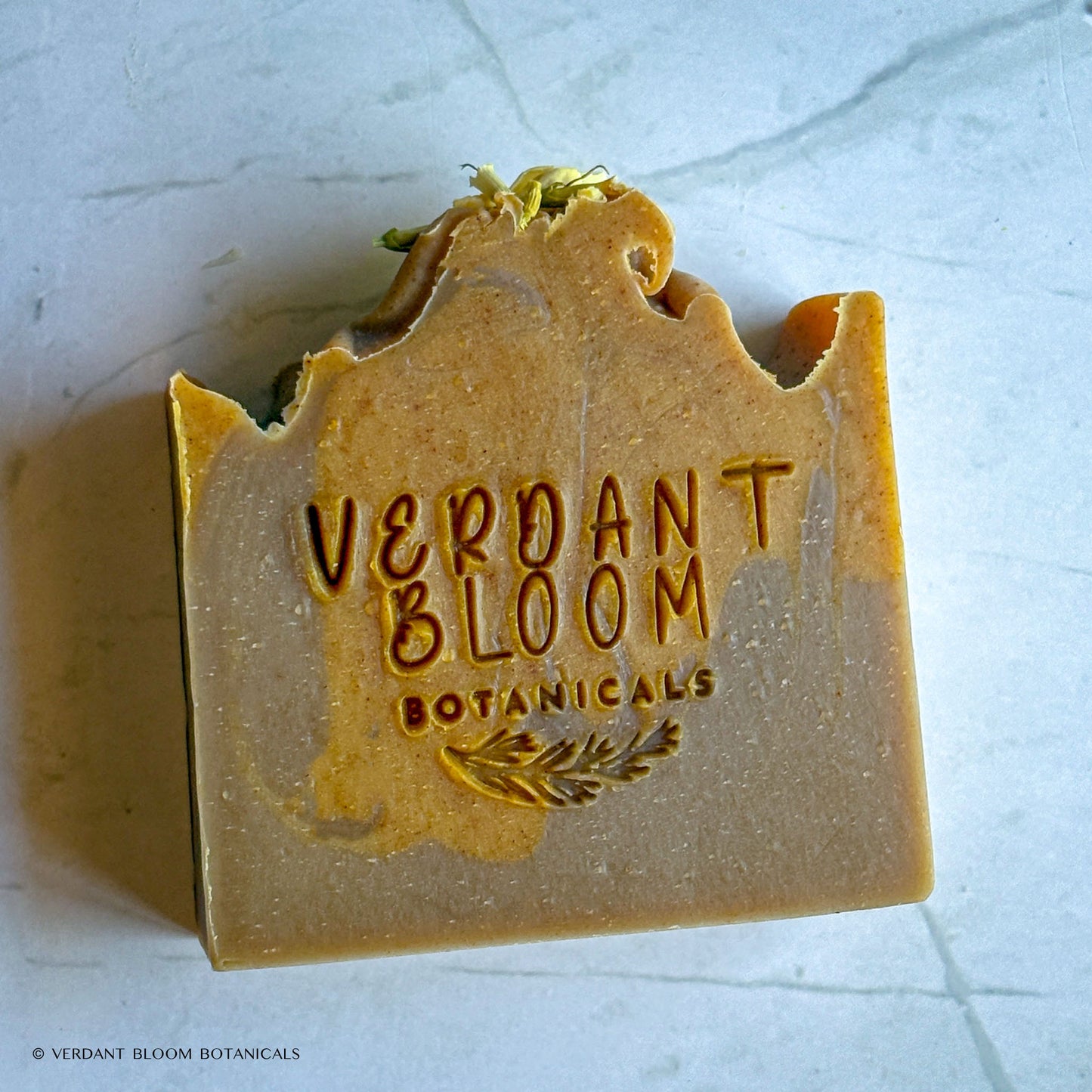 Honeyed clove soap stamped with logo