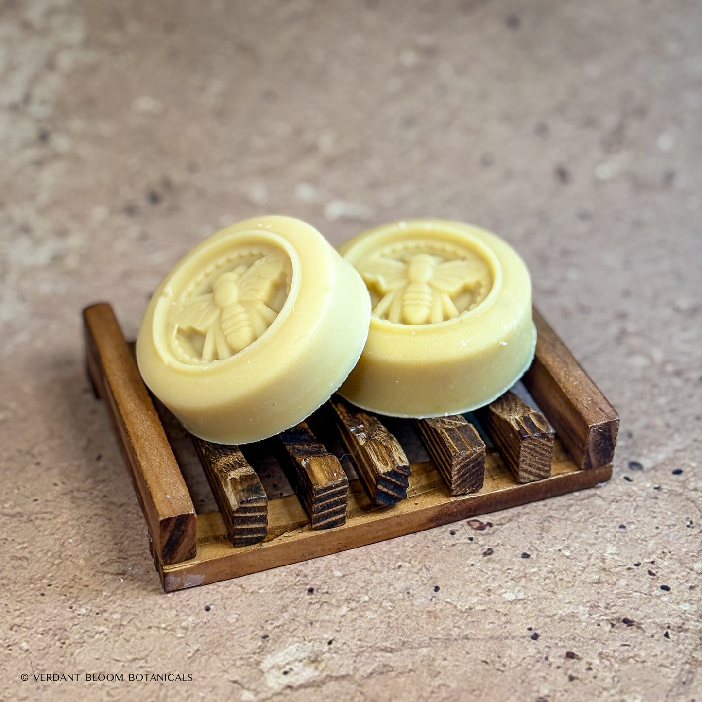 two Milk & Honey mini soaps on wooden soap holder