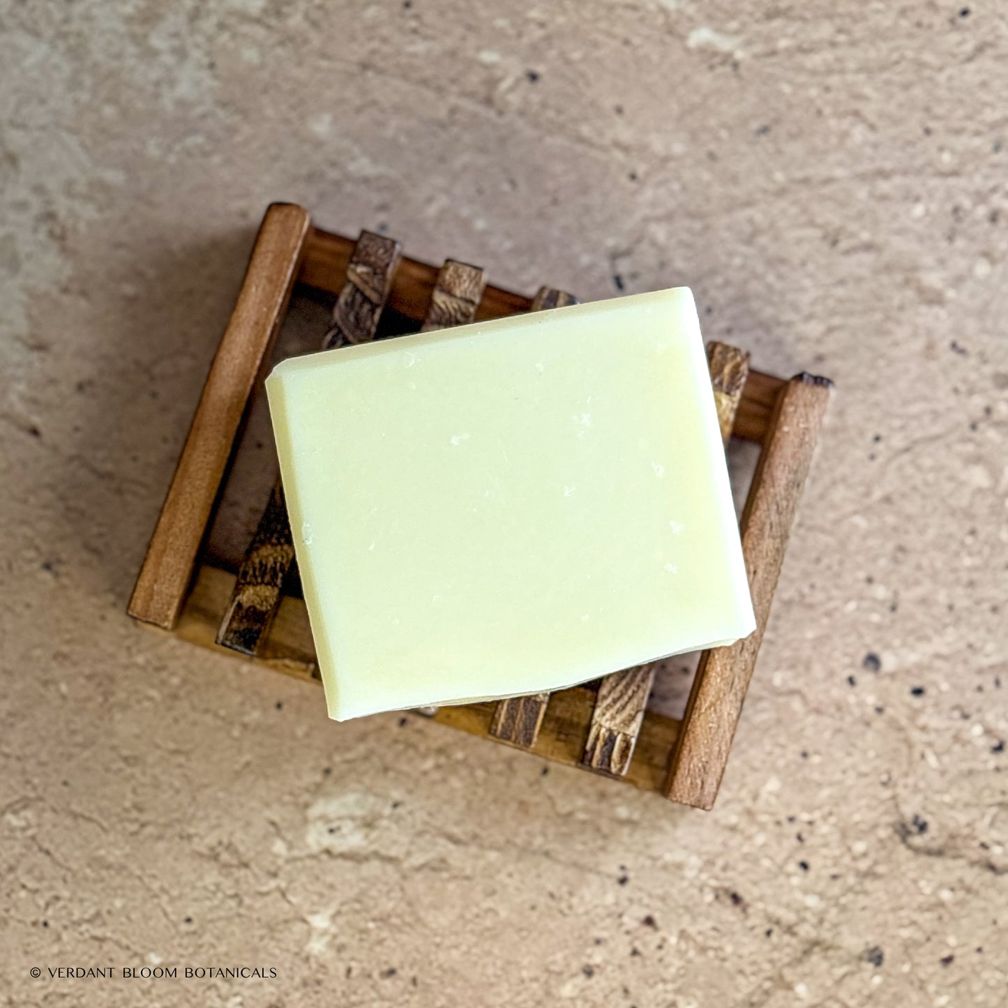 Raw Remedy soap bar on wooden soap holder
