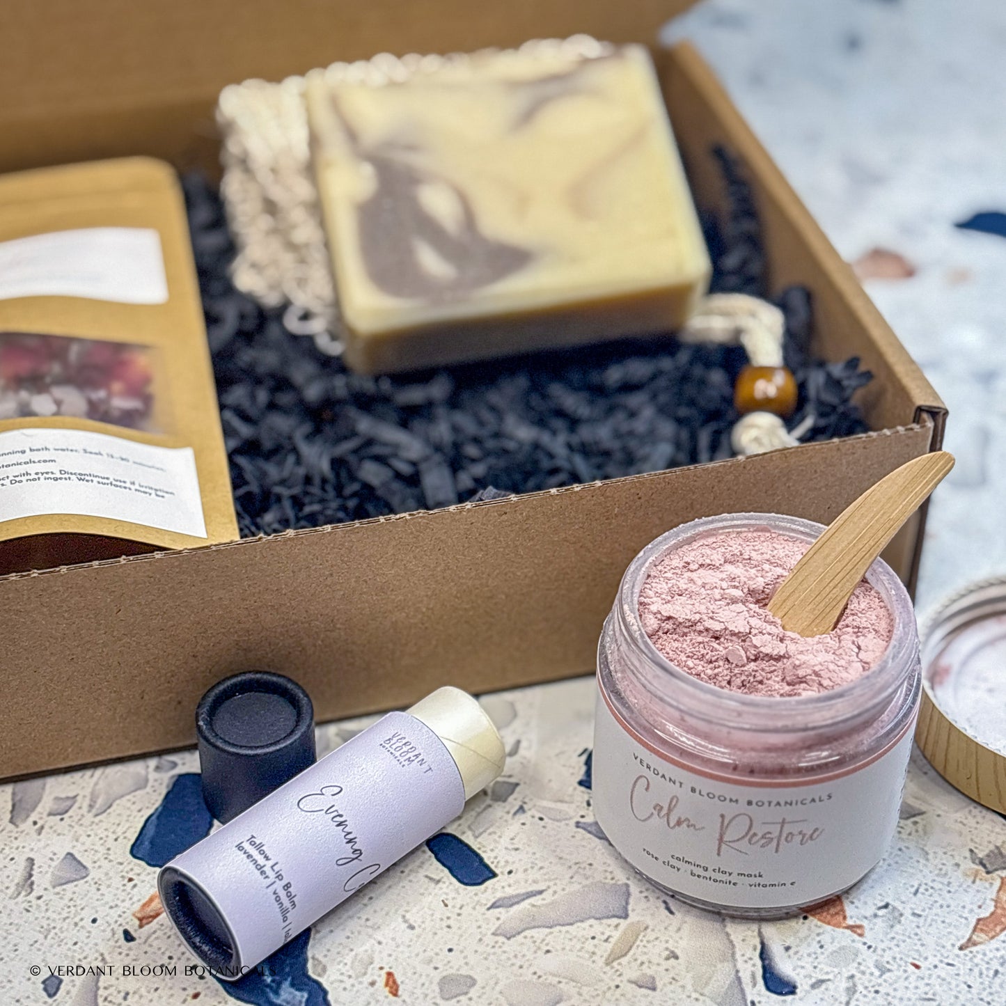 Wind-Down kit containing bath soak, face mask, goat milk soap, lip balm, and sisal soap bag in gift box
