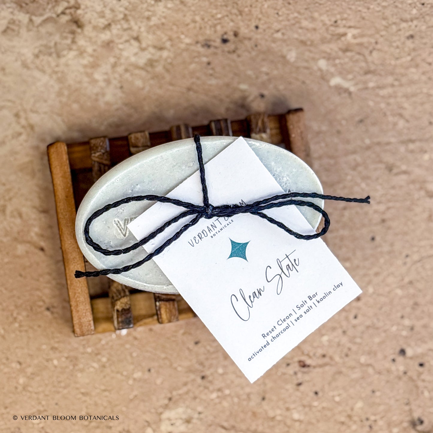 Clean Slate salt bar with label on wooden soap holder