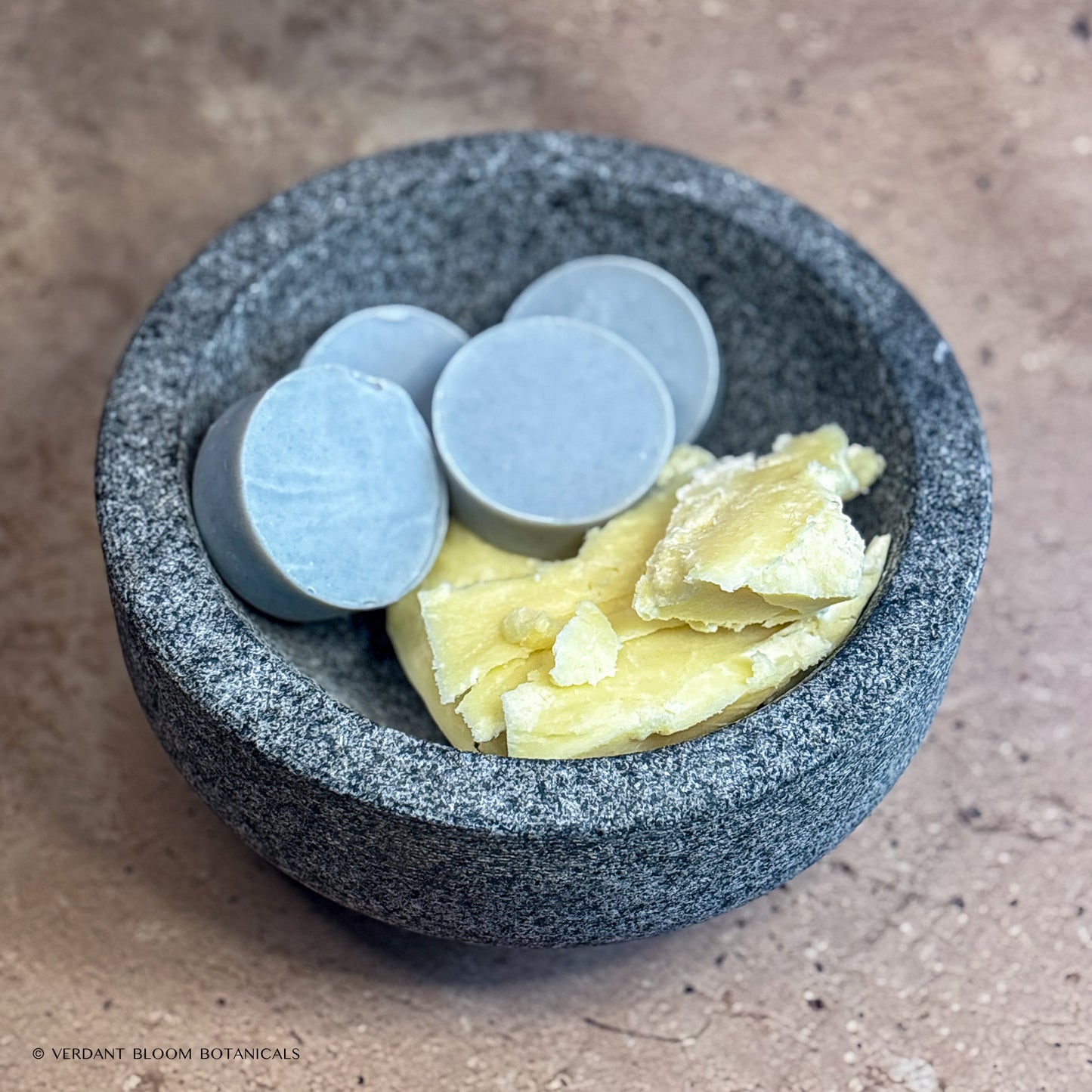 Collection of Common Ground mini soaps in bowl with shea butter
