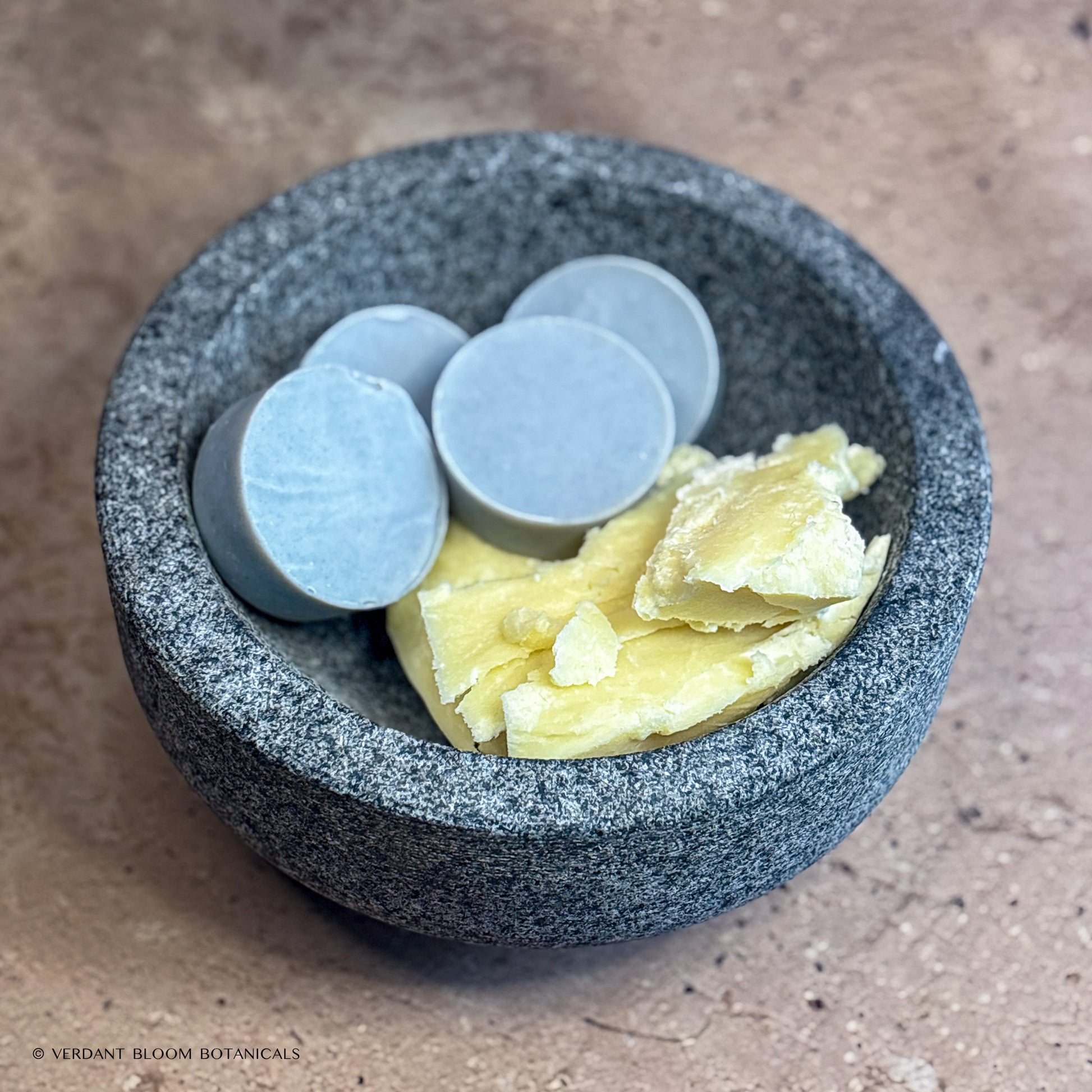 Collection of Common Ground mini soaps in bowl with shea butter