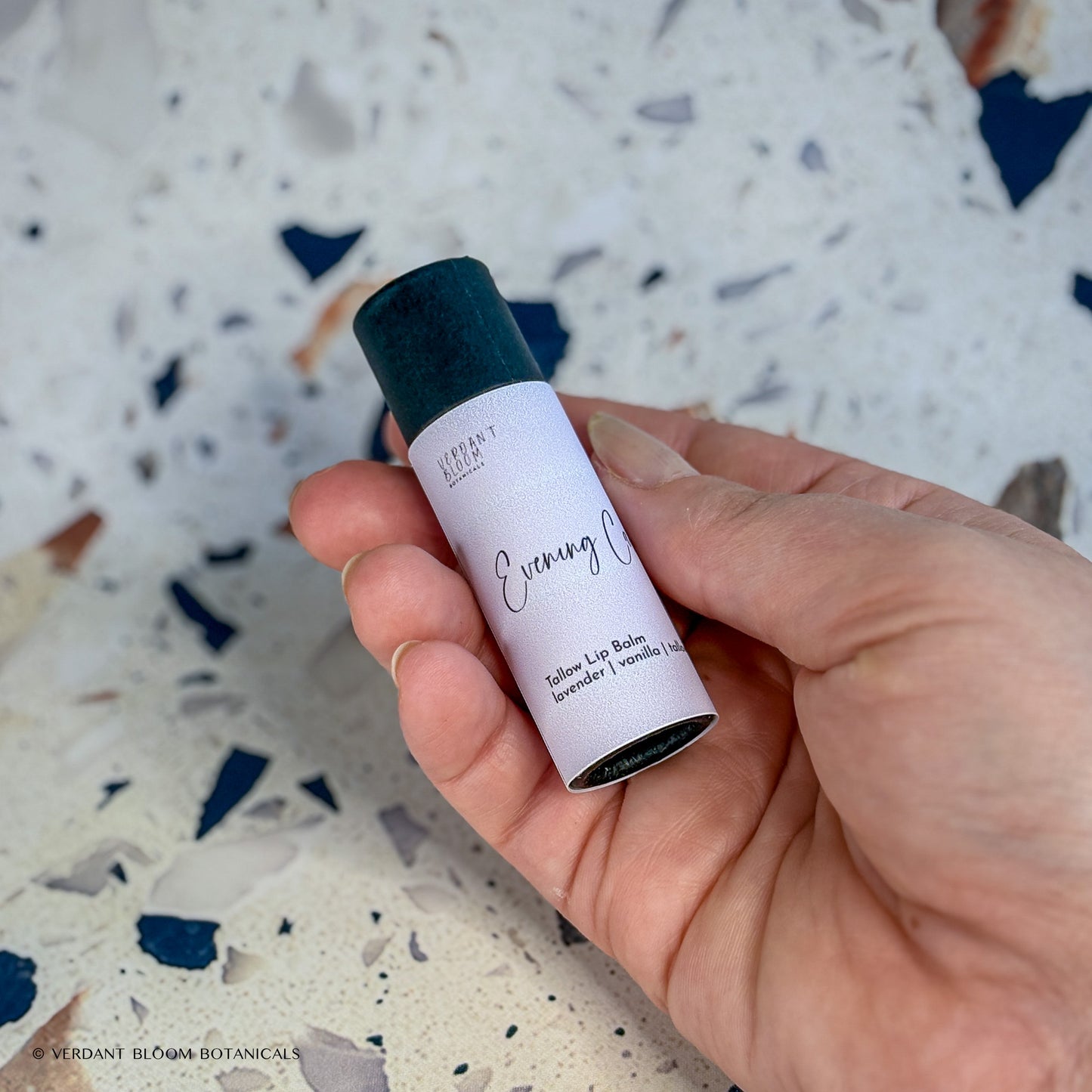 Evening Calm lip balm being held in hand