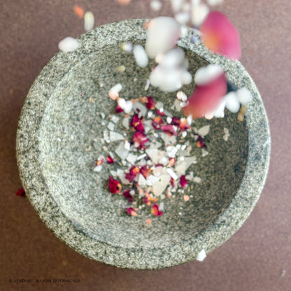 Floral Calm Bath soak pouring into granite bowl