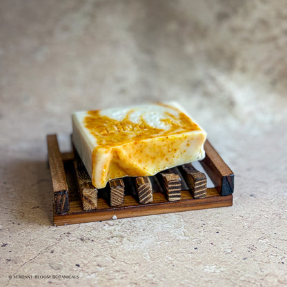 Golden Comfort soap bar on wooden soap tray