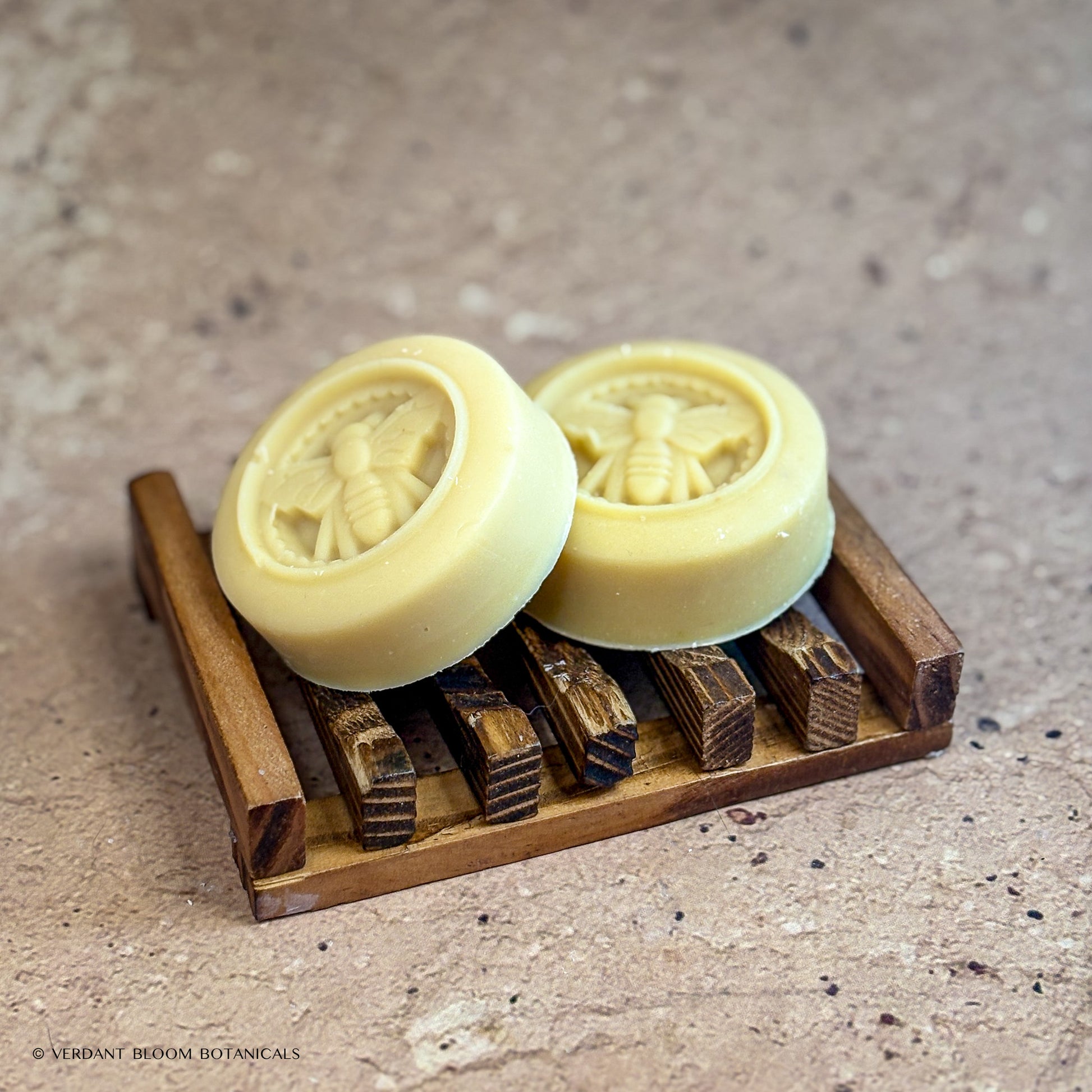 two Milk & Honey mini soaps on wooden soap holder