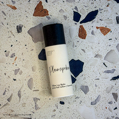 Plainspoken lip balm tube laying on table