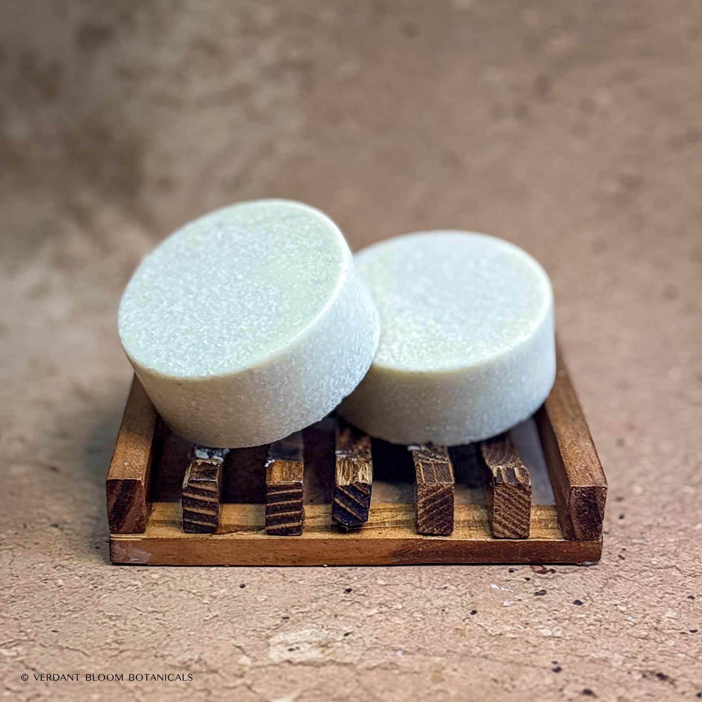 two Steam Room mini salt bars on wooden soap holder