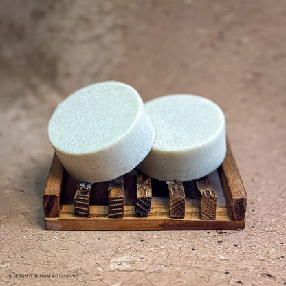 two Steam Room mini salt bars on wooden soap holder