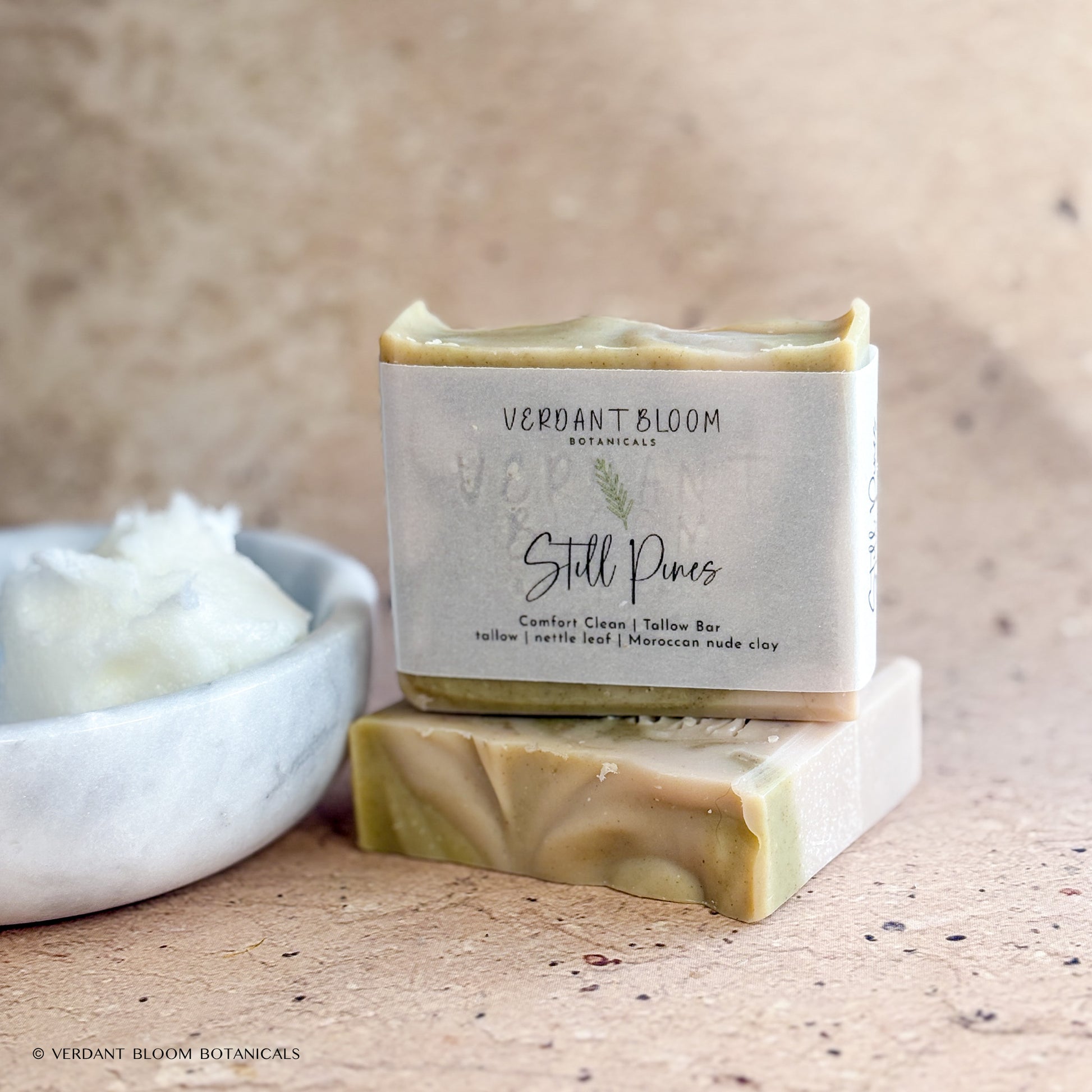 Still Pines soap bars next to bowl of tallow