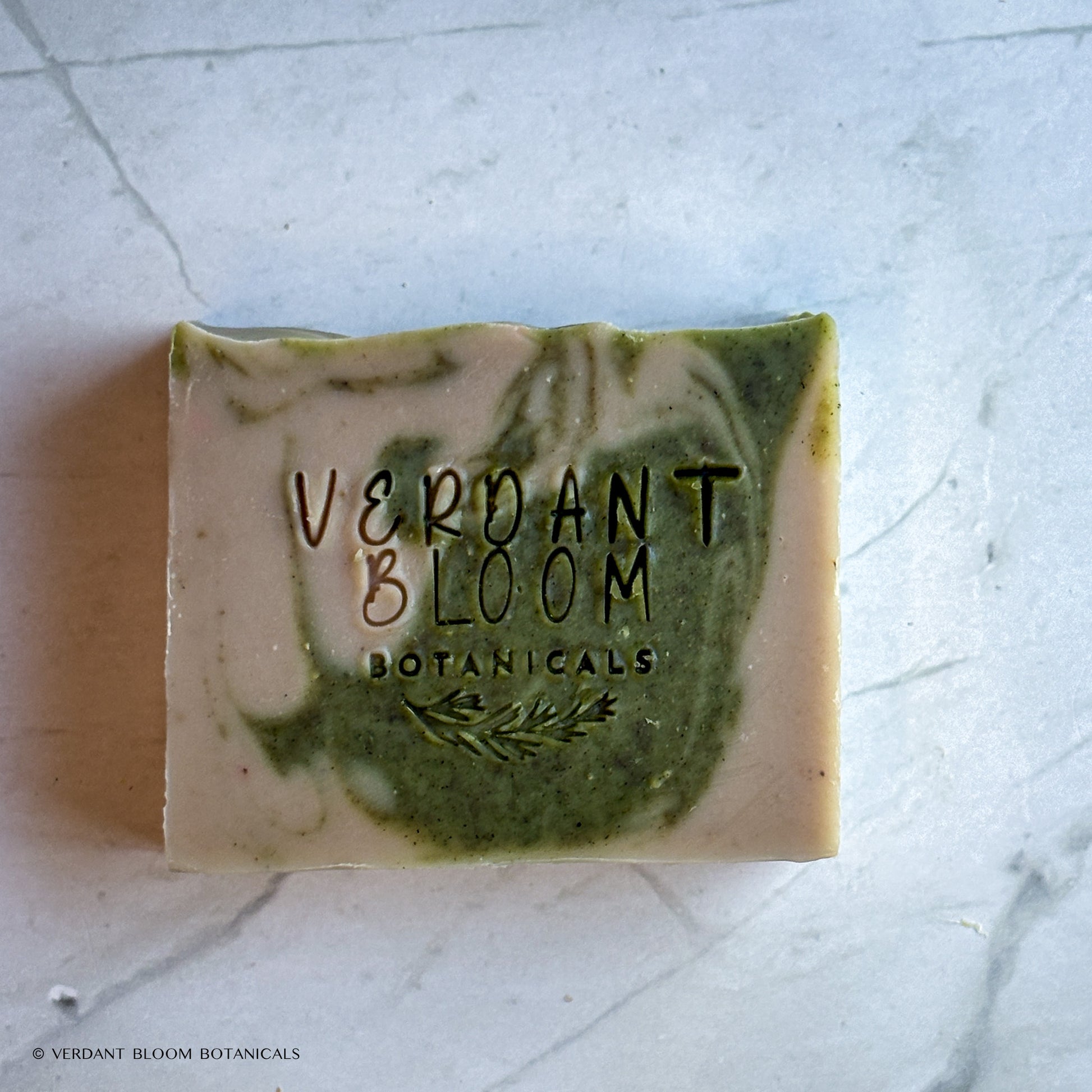 Hand‑cut Still Pines tallow soap bar in a green‑gray hue with natural clay texture and subtle botanical speckling.