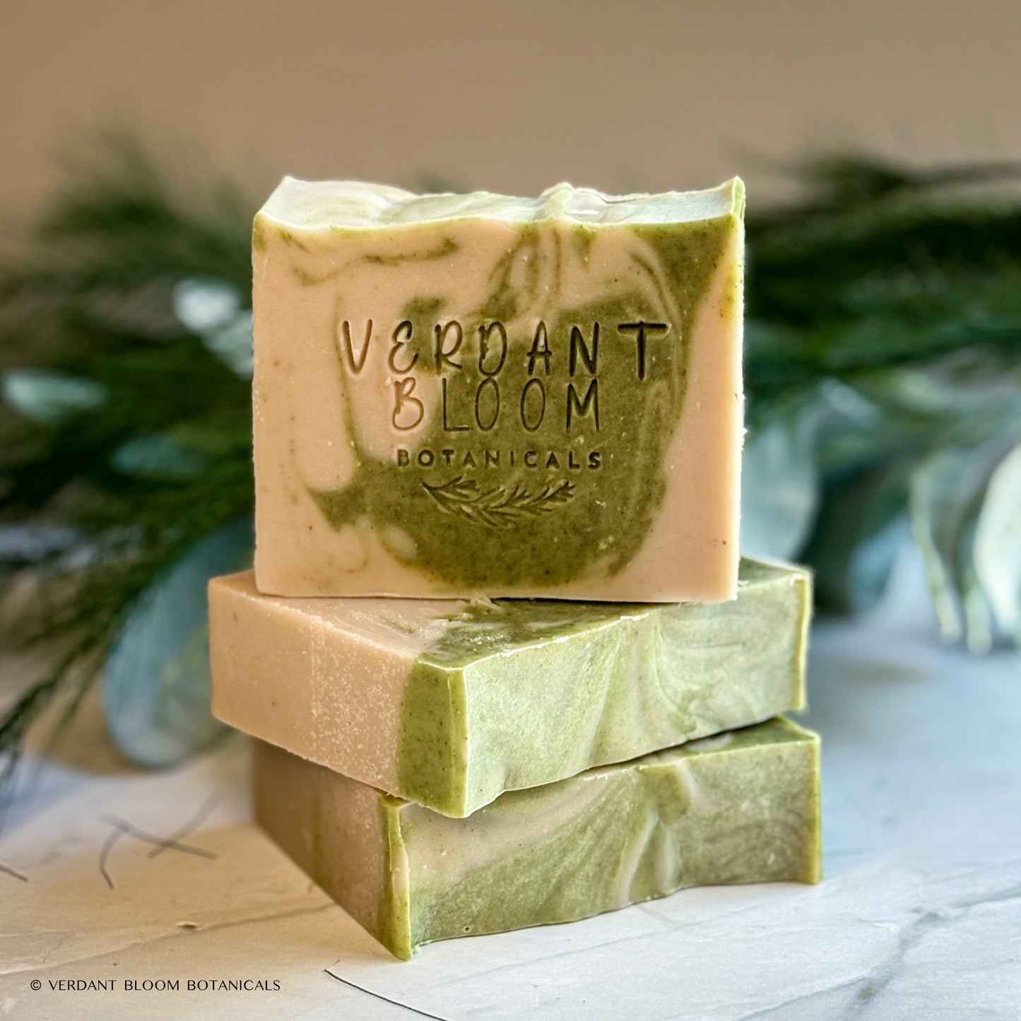 Hand‑cut Still Pines tallow soap bar in a green‑gray hue with natural clay texture and subtle botanical speckling.