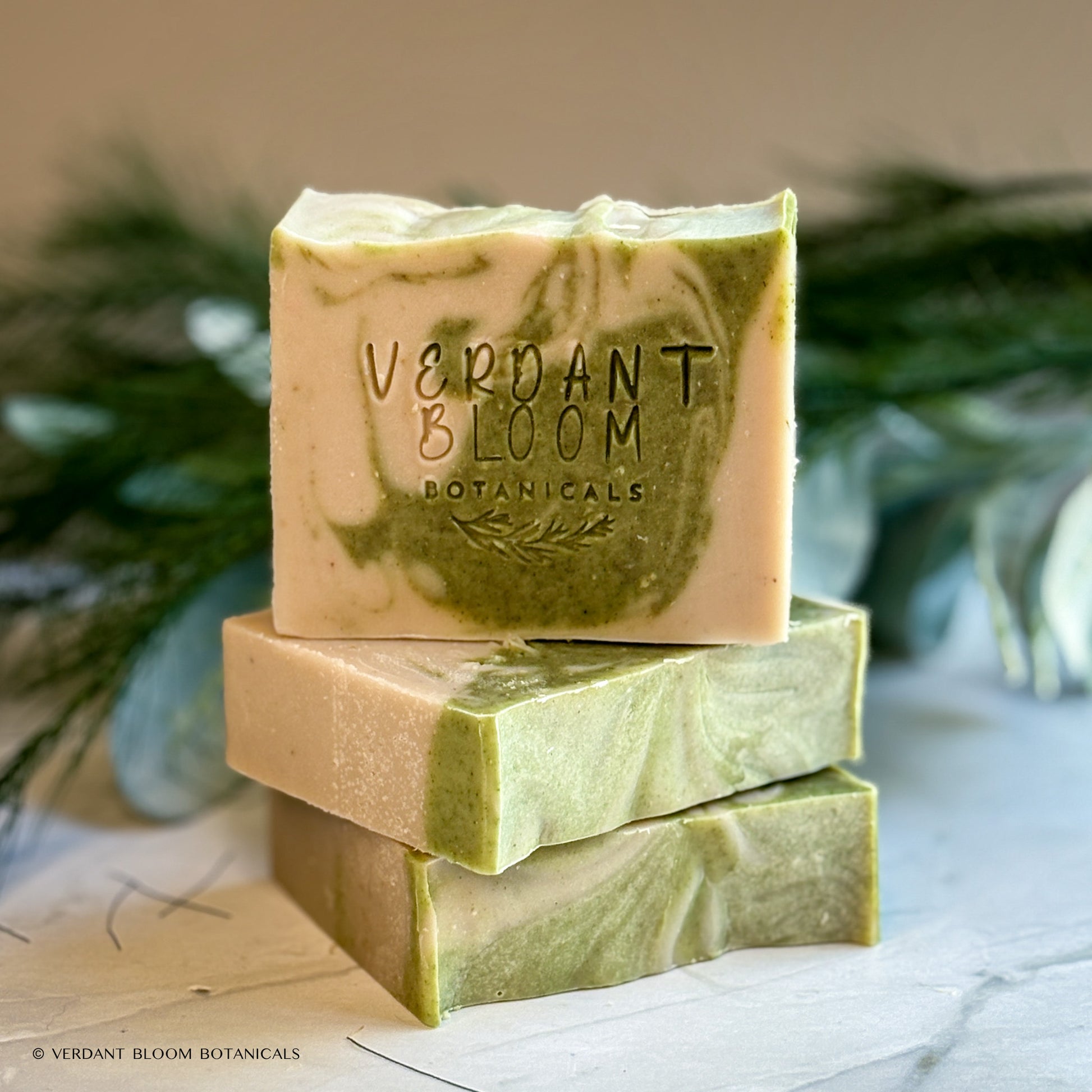 Hand‑cut Still Pines tallow soap bar in a green‑gray hue with natural clay texture and subtle botanical speckling.