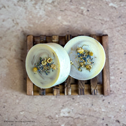 two Tranquil Bloom mini soaps on wooden soap holder