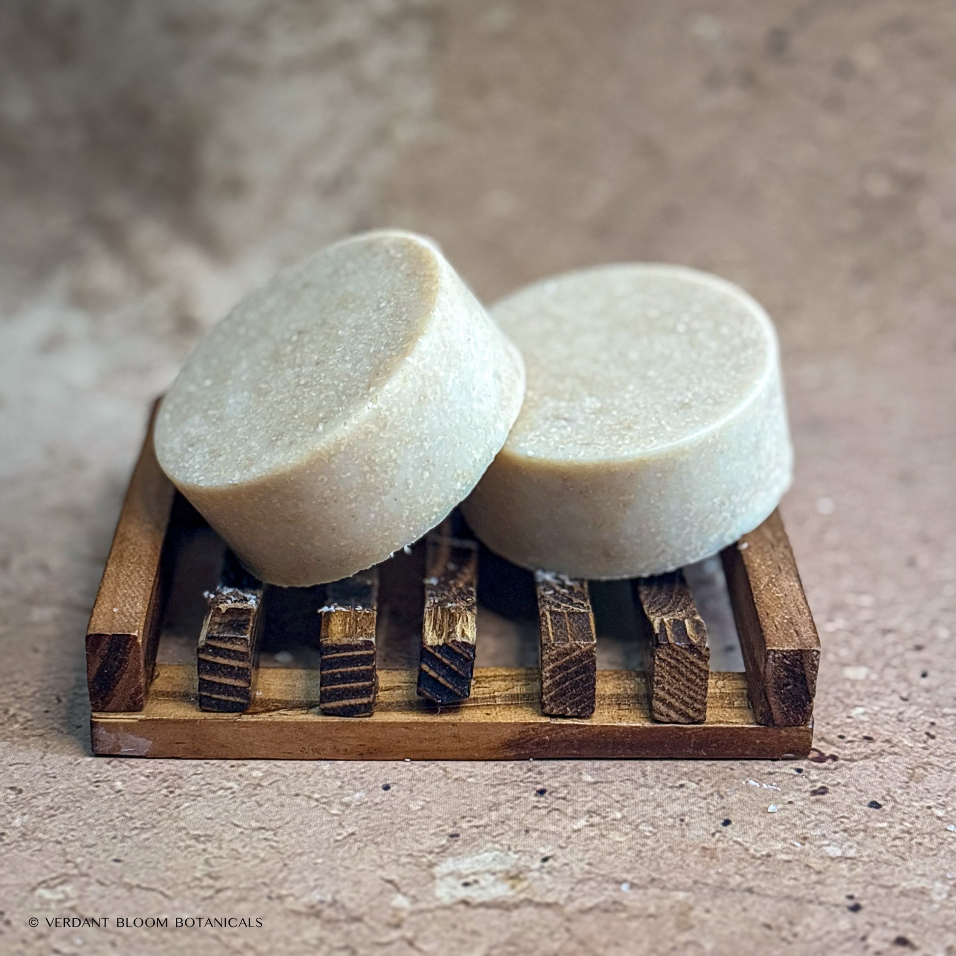 two Warm Stone mini salt bars on wooden soap holder